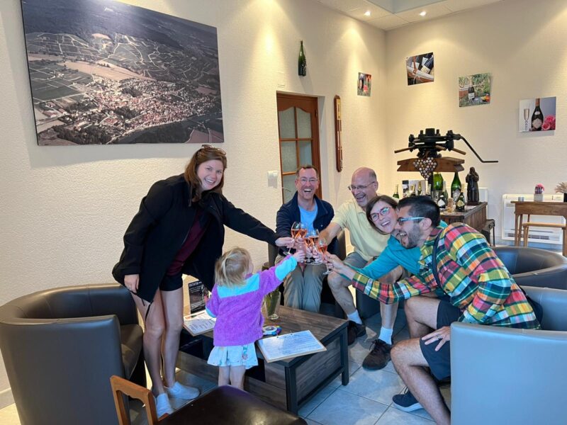 Group of people toasting with champagne glasses at a France Passion stopover.
