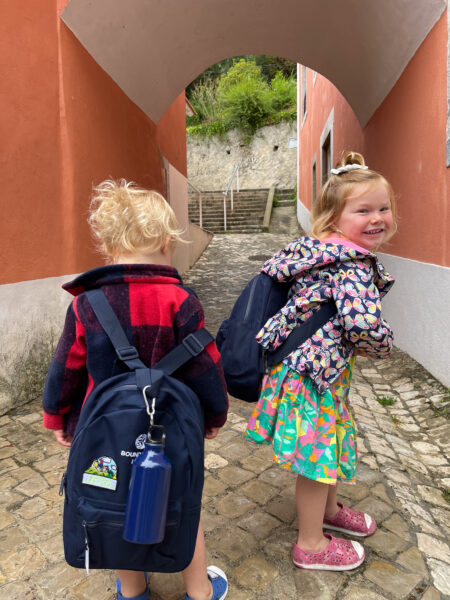Two kids in front of Boundless Life school in Portugal